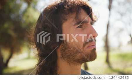 Long Hair Man Astonished To Read An Incomprehensible Poster On The Street 124442485
