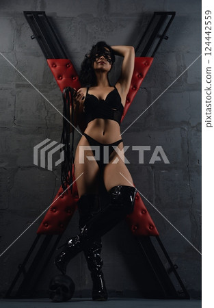 Woman in Black Lingerie With Whip Near Red X prepared for sexual bdsm game Woman in Black Lingerie With Whip Near Red X prepared for sexual bdsm game 124442559