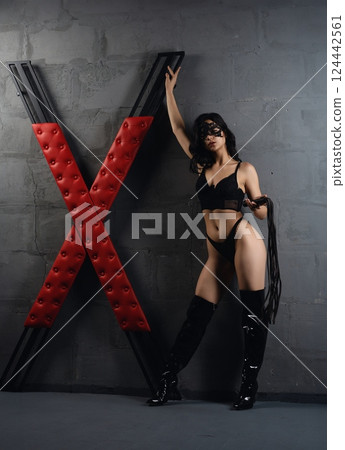 Woman Posing With Whip and Red X Cross prepared for sexual bdsm game Woman Posing With Whip and Red X Cross prepared for sexual bdsm game 124442561