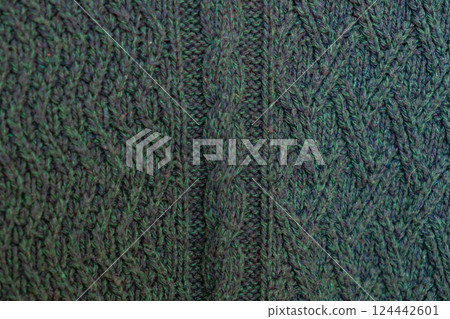 knitted texture, dark green sweater or carpet, pattern of back and front loops. knitted texture, dark green sweater or carpet, pattern of back and front loops. 124442601