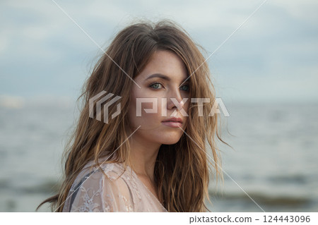 Young spring woman walking outdoors on nature background, fashion beauty portrait Young spring woman walking outdoors on nature background, fashion beauty portrait 124443096