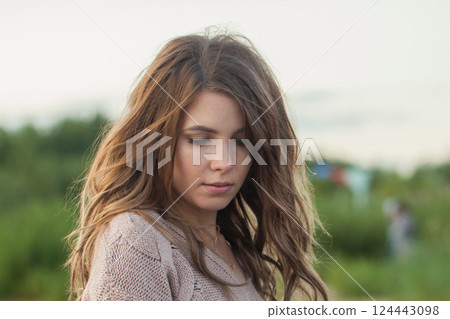 Nice spring woman walking outdoors on nature background, fashion beauty portrait 124443098