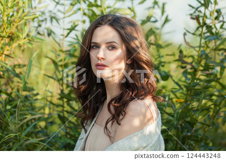 Close-up face of spring woman walking outdoors on nature background, fashion beauty portrait Close-up face of spring woman walking outdoors on nature background, fashion beauty portrait 124443248