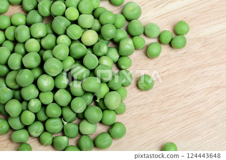 Green peas on wooden board table background 124443648