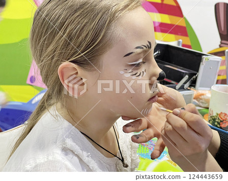Brunette child girl waiting while getting creative patry makeup 124443659