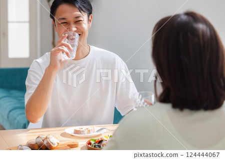 A man drinking a glass of water A man drinking a glass of water 124444067