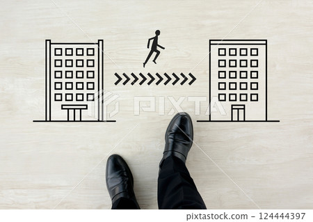 Image of the feet of a businessman moving between companies, such as changing jobs Image of the feet of a businessman moving between companies, such as changing jobs 124444397