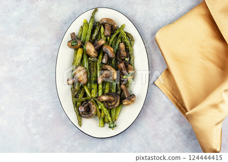 Baked asparagus spears with mushrooms. 124444415