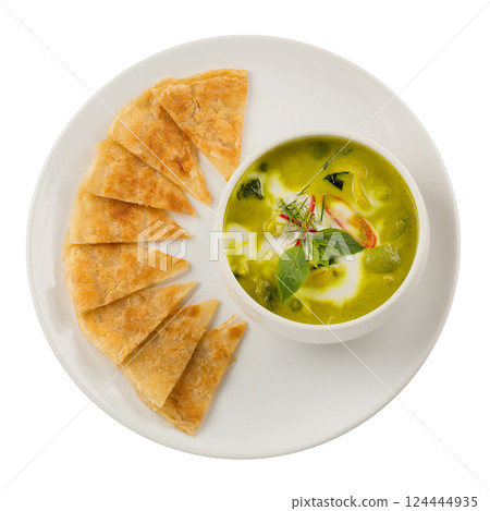 Thai green curry chicken with roti in white container isolated on a white background. Thai green curry chicken with roti in white container isolated on a white background. 124444935