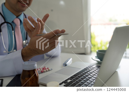 Patient Monitoring and Care Strategies. Physician discussing health matters while managing medications. 124445008