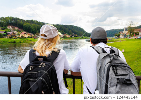 Scenic young adult happy woman portrait enjoy tourism trip Sachsische Schweiz National Park Germany Whelen Koenigstein mountain valley blue sky sunny day. Europe travel nature landscape destination 124445144