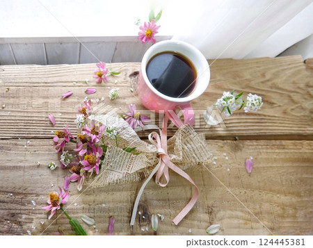 Pink zinnias and pink cups on the windowsill 124445381