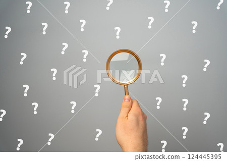 Magnifying glass with a many question mark. Looking for an answer. Search and analysis, analytics and study. Pay attention to details and problems. Find something. Journalistic investigations Magnifying glass with a many question mark. Looking for an answer. Search and analysis, analytics and study. Pay attention to details and problems. Find something. Journalistic investigations 124445395
