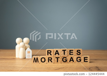 Loan and credit interest. Apartments, housing and house. Real estate market analysis concept. Business and finance. Wooden blocks with the words Rates mortgage and family with house. 124445444