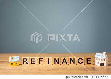 Wooden blocks with the words Refinance and miniature houses. Real estate concept. Business and finance. Mortgage, loan. Interest rates. Home lending Wooden blocks with the words Refinance and miniature houses. Real estate concept. Business and finance. Mortgage, loan. Interest rates. Home lending 124445445