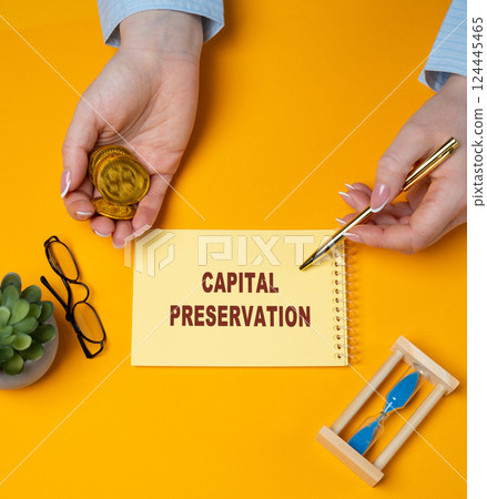 Capital preservation concept. Investment strategy aimed at protecting the principal while minimizing the risk of losing money. Business and finance. A woman writes in notes 124445465