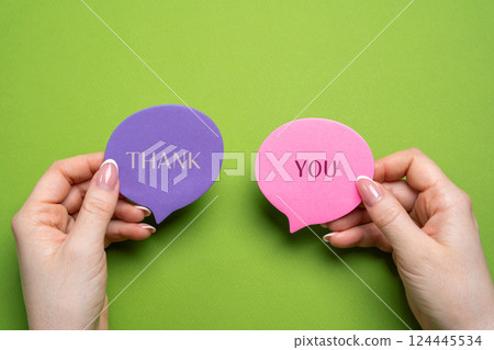 Thank you on notes in female hands. Expressing gratitude, acknowledgment or appreciation concept. Gratitude and appreciation. Feedback 124445534