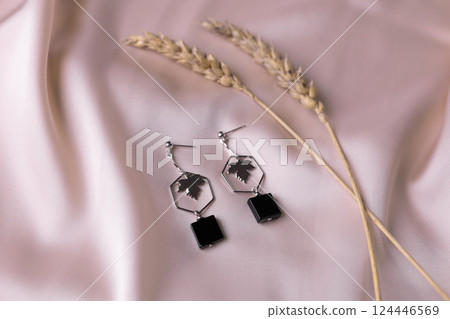 Women's Jewelry. Trendy jewelry on silk background. Flat lay, top view. Women's Jewelry. Trendy jewelry on silk background. Flat lay, top view. 124446569