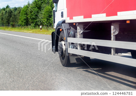 Specialized trucks with a carrying capacity of up to 5 tons transport cargo along the highway in the summer, industry. Copy space for text 124446781