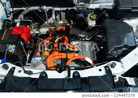 Electric car with open hood. Close up of inverter and wires 124447379