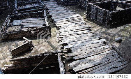 Ancient historical excavations in a museum with wooden village houses. Historical excavations, background Ancient historical excavations in a museum with wooden village houses. Historical excavations, background 124447582