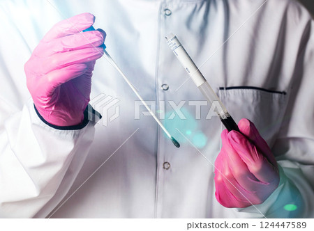 Doctor gynecologist with a medical probe to collect infections from the cervical canal in women for hidden infections. Sexually transmitted infections, close-up 124447589
