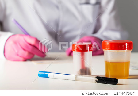 Analyzes of ejaculate, urine and feces on the table against the background of a doctor laboratory assistant. Concept for identifying infections in bacterial culture tests, copy space for text Analyzes of ejaculate, urine and feces on the table against the background of a doctor laboratory assistant. Concept for identifying infections in bacterial culture tests, copy space for text 124447594