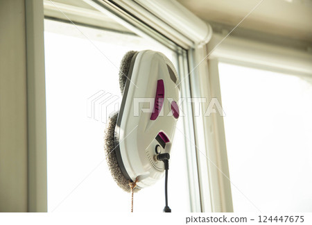 Modern device for cleaning glass from dirt and streaks. Robot washer vacuum cleaner with microfiber. Safety for window cleaning and fall protection. Modern device for cleaning glass from dirt and streaks. Robot washer vacuum cleaner with microfiber. Safety for window cleaning and fall protection. 124447675