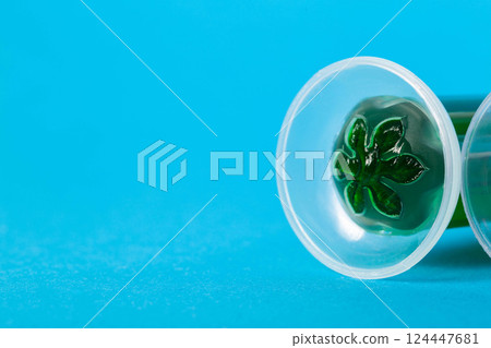 Syringe with green cleaning gel for toilet bowl on blue background. Copy space for text, aromatization 124447681