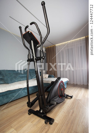 New modern elliptical trainer at home in the exercise room, close-up 124447712