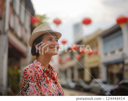 woman exploring streets of George Town, during Chinese New Year. 124448414