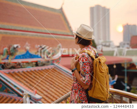 Woman Exploring Colorful Streets Near Buddhist Temples in Bangkok Woman Exploring Colorful Streets Near Buddhist Temples in Bangkok 124448433