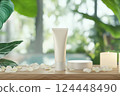Cream tube mock-up on a wooden surface, flower petals and aromatic candles 124448490