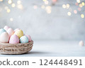 Pastel Easter eggs in baskets on light background 124448491