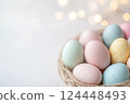 Pastel Easter eggs in baskets on light background 124448493
