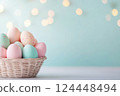 Pastel Easter eggs in baskets on light background 124448494