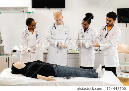 Medical Students Wearing Gloves During CPR Training on a Dummy Medical Students Wearing Gloves During CPR Training on a Dummy 124448500