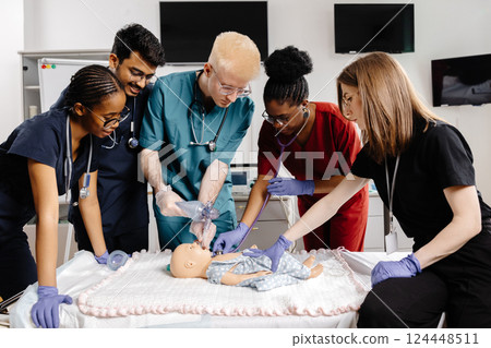 Medical Students Practicing Intubation Technique on Baby Mannequin during Training Medical Students Practicing Intubation Technique on Baby Mannequin during Training 124448511