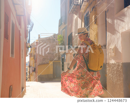 Woman strolls through colorful streets of Spanish coastal town Woman strolls through colorful streets of Spanish coastal town 124448673