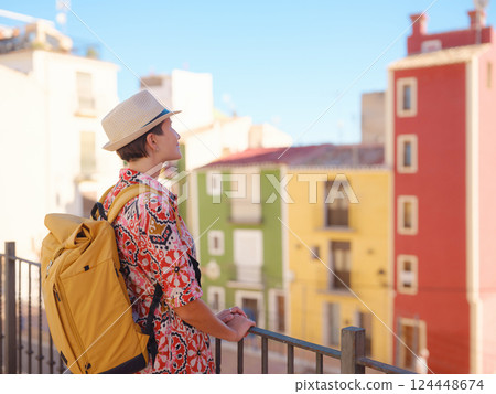 Woman strolls through colorful streets of Spanish coastal town 124448674