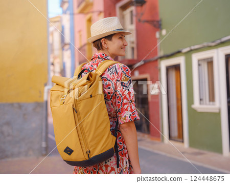 Woman strolls through colorful streets of Spanish coastal town Woman strolls through colorful streets of Spanish coastal town 124448675