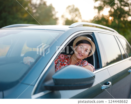 Traveler woman drives car through scenic countryside of Croatia 124448682