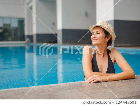 Young woman relaxing by the pool at a Kuala Lumpur hotel 124448691
