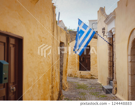 View of Greek flag waving in air serene Mediterranean vibe. View of Greek flag waving in air serene Mediterranean vibe. 124448883