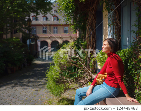 Tourist woman enjoys historic charm of Hochst near Frankfurt Tourist woman enjoys historic charm of Hochst near Frankfurt 124449468