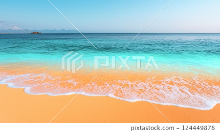 A serene beach scene with golden sand and crystal-clear turquoise waters under a clear blue sky. 124449878