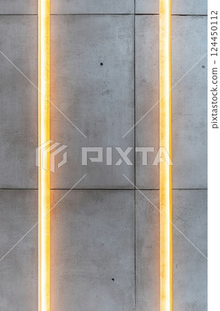 Concrete surface illuminated by soft golden light streaks creates a high-end luxury aesthetic, ideal for minimalistic and contemporary designs, offering ample space for text and graphics 124450112