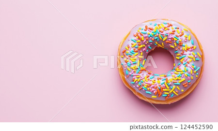 A colorful donut with pink icing and sprinkles 124452590