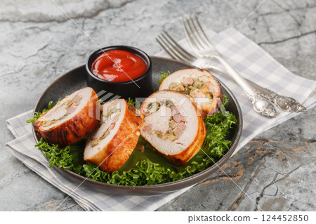 Juicy turkey roll with bacon, onions and mushrooms close-up in a plate. Horizontal Juicy turkey roll with bacon, onions and mushrooms close-up in a plate. Horizontal 124452850