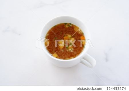 Hot onion consommé soup Hot onion consommé soup 124453274